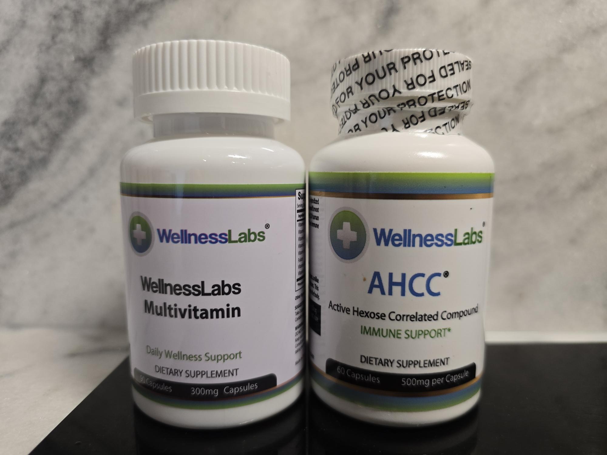 WellnessLabs Multivitamin and WellnessLabs AHCC supplement bottles on a marble background